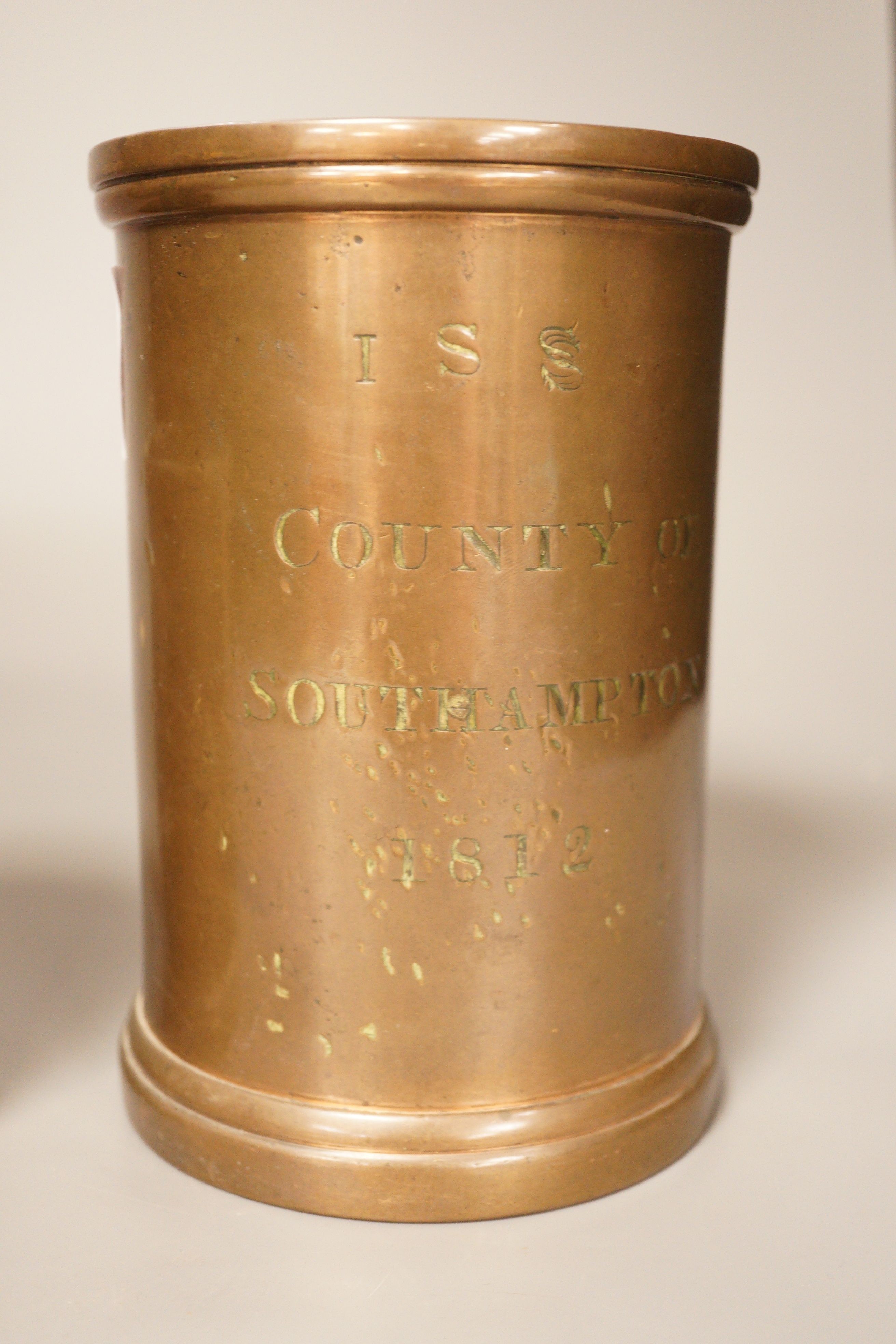 Three early 19th century graduated bronze measures, the larger marked ‘quart Winchester’, the others marked ‘County of Southampton, 1812 (3). 17cm